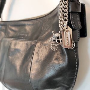 Coach black leather handbag, with charms.